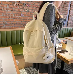 Minimalist beige casual backpack detail showcasing front pocket design and daily lifestyle use.