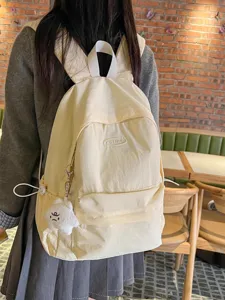 Lightweight minimalist solid color backpack casual college school bag for women daily outing.