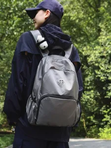 Lightweight grey travel backpack for outdoor sports, casual daily use, and large capacity.