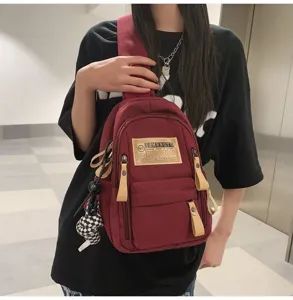 Casual canvas chest bag with zipper pocket and checkered charm for daily travel and sports use.