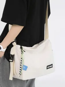Japanese casual canvas messenger bag for women and men, solid color crossbody shoulder bag.
