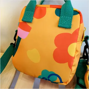 Cute canvas crossbody bag for women, vibrant floral print design with green straps, trendy.