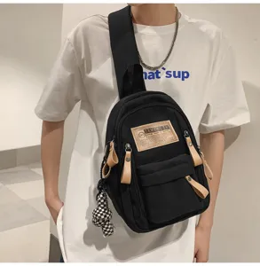 Black canvas sling bag for men and women, casual chest backpack with pocket and keychain.