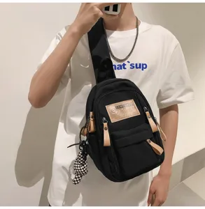 Black canvas chest bag for men and women, stylish streetwear sling backpack with zipper.