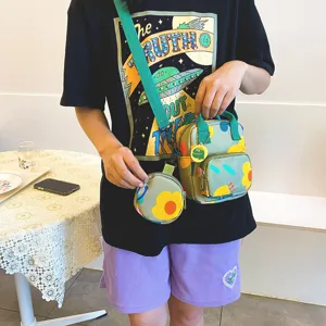 Green canvas mini crossbody bag with coin purse and cute frog pendant for casual daily wear