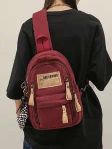 Canvas sling backpack for women and men, casual crossbody bag with multi pockets and charm.