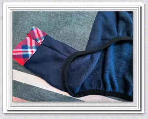 Thickened warm dog fleece clothing detail, cozy winter pet apparel with plaid cuff trim.