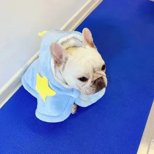 Detail view of winter warm pet cloak pajamas, cute blue hooded cape with yellow star.
