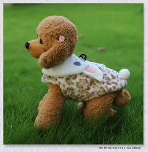 Detailed view of cute plush pet dog clothes with rabbit ear design and leopard print.