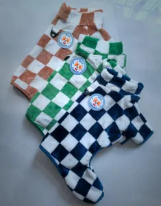Detailed view of warm fleece four-leg pet clothes featuring cozy checkerboard pattern designs.