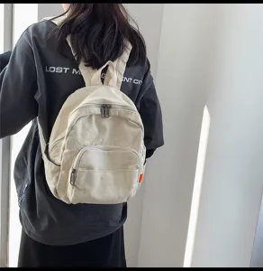 Minimalist canvas backpack for women, casual retro school bag with multiple pockets in solid color