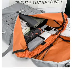 Large capacity grey tactical backpack detail showing orange interior lining and spacious storage.