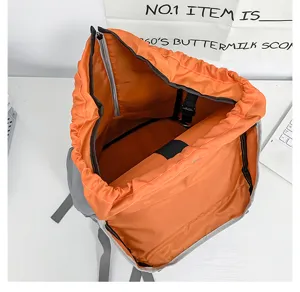 Detail view of large capacity utility backpack interior storage structure showing orange lining.