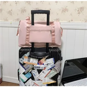 Lightweight pink travel duffel bag with luggage sleeve, large capacity gym bag for women.