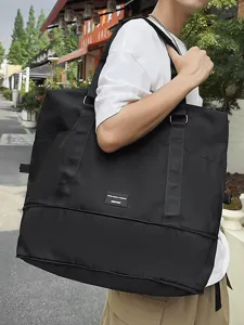 Large capacity black travel duffel bag worn on shoulder, lightweight and expandable for trips.