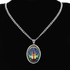 Detailed view of the colorful stained glass tree of life oval pendant necklace close up.