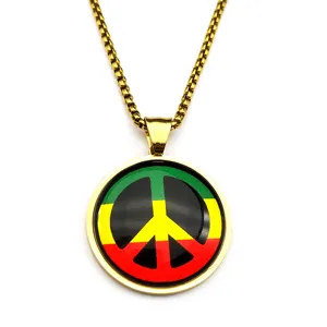 Gold chain necklace with round glass cabochon pendant, featuring peace sign and reggae colors.