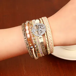 Bohemian multi-layer leather wrap bracelet featuring a sparkling crystal tree of life charm.