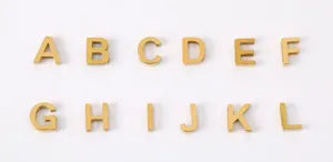 Gold metal letter charms pendant alphabet DIY jewelry making accessories, clean flat lay view.