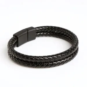 Detail shot of a black braided leather bracelet with a sleek magnetic clasp for men daily wear.