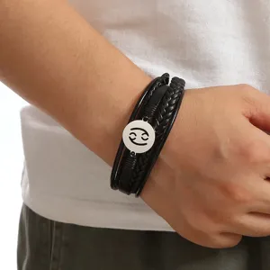 Men's multi-layer braided leather bracelet featuring a stainless steel Cancer zodiac charm detail.