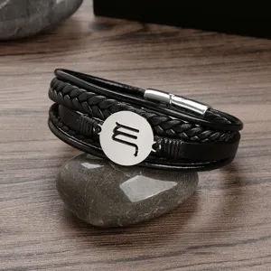 Detail close-up view showcasing the multi-layer leather bracelet with a stainless steel disc.