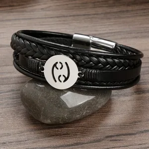Men's multi-layer braided leather bracelet with stainless steel zodiac charm and magnetic clasp.