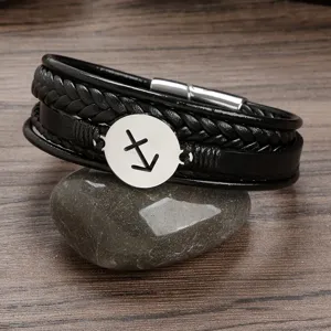 Men's multi-layer braided leather bracelet with stainless steel zodiac charm and magnetic clasp.