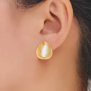Gold teardrop stud earrings featuring a glowing white center stone, elegant detail view.