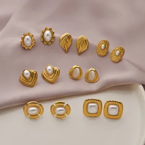 Close-up detail of vintage gold-plated geometric pearl stud earrings set, elegant design.