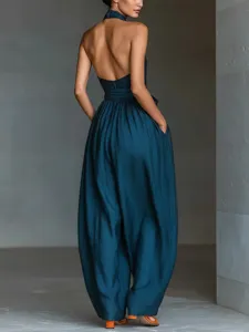 Back view of women's linen halter wide-leg jumpsuit, featuring criss-cross back straps.