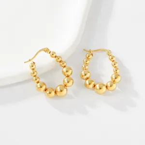 Detailed close-up view of 18k gold plated beaded stainless steel hoop earrings for women.