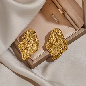 Gold irregular melted texture metal stud earrings detail shot showcasing unique modern design.