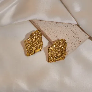 Gold irregular metal texture earrings detail shot close up fashion jewelry style