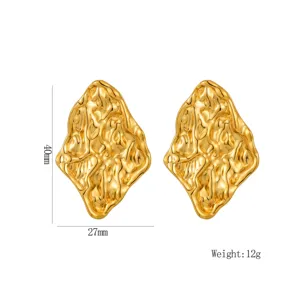 Gold irregular molten metal stud earrings detail view, showing unique textured surface.