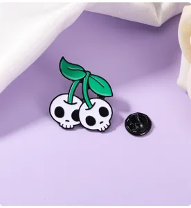 Close-up detail of punk skull cherry enamel pin, cartoon alloy brooch, clothing decor.