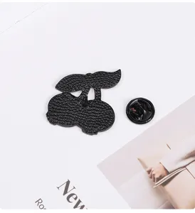Black cherry shape metal brooch pin with back clutch accessory for clothing decoration.
