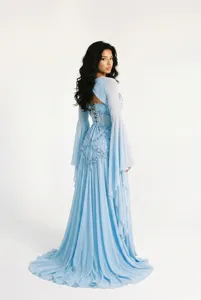 Light blue long evening dress with corset bodice, bell sleeves, and delicate beading.