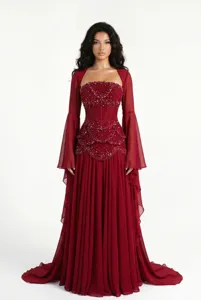 Details of wine red evening gown, featuring beaded corset bodice and sheer flared sleeves.
