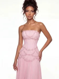 Pink strapless corset evening dress with delicate bead embroidery and fishbone waist detail.