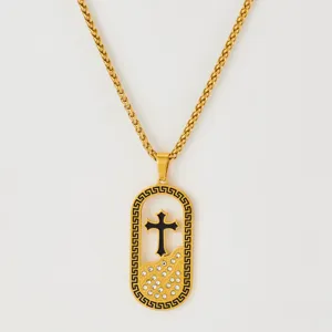 Gold-tone cross pendant necklace with Greek key border and sparkling crystal details.