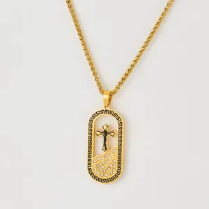 Gold stainless steel cross pendant necklace with rhinestones and Greek key border design.