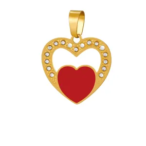 Gold-tone heart pendant featuring clear crystal pavé setting and vibrant red enamel center.