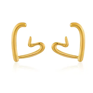 Detail shot of abstract gold heart earrings showing smooth metallic finish and shape.