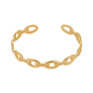 Detailed close-up shot of gold stainless steel chain cuff bracelet with geometric irregular links.