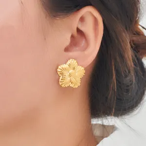 Elegant gold stainless steel flower stud earrings with detailed petal design for women.