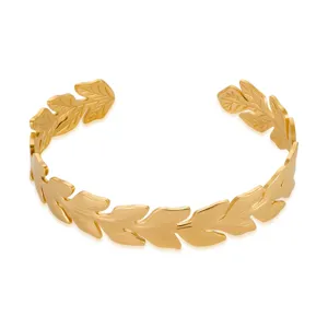 Close-up detail of the 18k gold plated stainless steel leaf cuff bracelet texture and finish.