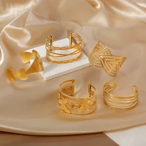 Detailed close-up view of 18k gold stainless steel open cuff bracelets with bohemian cutouts.