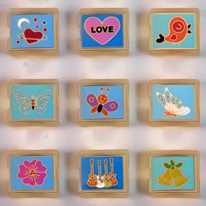 Detailed view of colorful enamel Italian modular bracelet links, DIY stainless steel charm pieces.