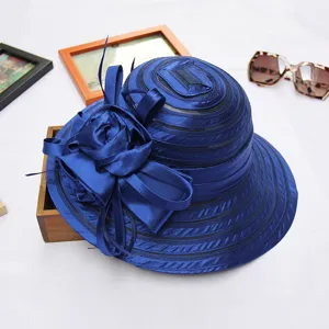 Detail shot of the deep blue crystal organza women dress hat, elegant floral decoration.